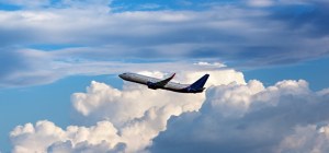 Modern passenger airliner flying in the cloudy sky